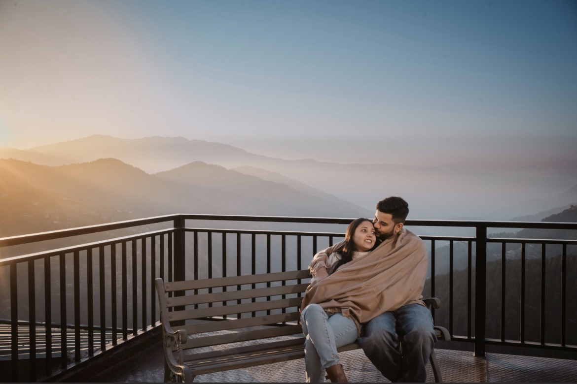 Couple watching the sunrise from the rooftop terrace at Hardys Retreat, Chail